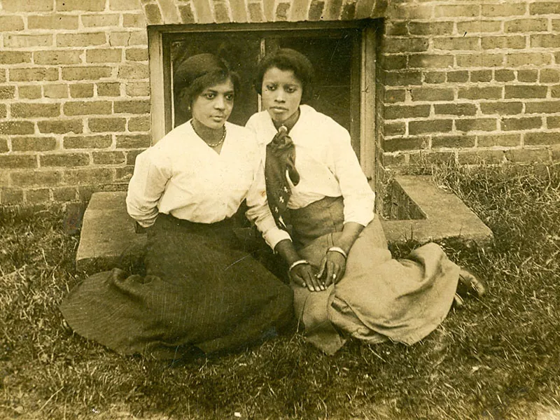 two women sit for portrait