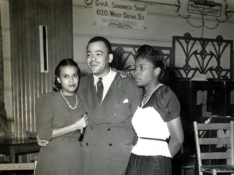 Arnett Cobb standing with his wife Elizabeth Cobb and unknown woman.