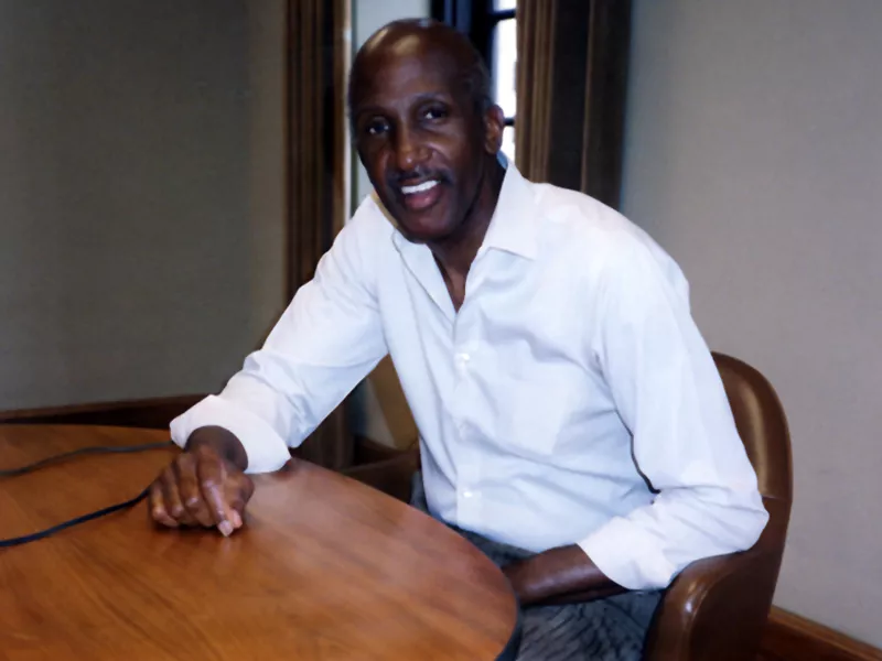 Wilton Felder sitting at a table in a white button down shirt.