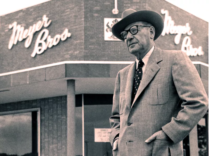 Leopold Meyer standing in front of a Meyer Bros store
